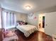 Bedroom showcasing a bed with decorative pillows and an adjacent bathroom at 4825 Samuel Richard St, Kannapolis, NC 28083