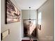Bright hallway with wood floors and artwork, leading to the upper level of the home at 4825 Samuel Richard St, Kannapolis, NC 28083