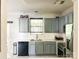 The modernized kitchen features gray cabinets, stainless steel appliances and marble countertops at 4825 Samuel Richard St, Kannapolis, NC 28083