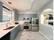Modern kitchen featuring stainless steel appliances, white marble countertops, and gray cabinetry at 4825 Samuel Richard St, Kannapolis, NC 28083