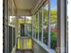 Relaxing screened porch with white railings and view of the landscaped yard and neighborhood at 4825 Samuel Richard St, Kannapolis, NC 28083