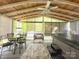 The patio features a dining area, lounge area, and a hot tub under a beamed ceiling with a fan at 4825 Samuel Richard St, Kannapolis, NC 28083