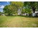 A green backyard with grass and large, mature trees on the property at 495&501 Turnersburg Hwy, Statesville, NC 28625