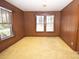 Cozy bedroom featuring paneled walls, plush carpet, and windows with natural light at 495&501 Turnersburg Hwy, Statesville, NC 28625