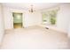 Spacious dining room featuring a chandelier and a large window for ample natural light at 495&501 Turnersburg Hwy, Statesville, NC 28625