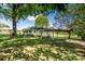 Exterior side view of the home featuring a carport and landscaped yard on a sunny day with partial shade at 495&501 Turnersburg Hwy, Statesville, NC 28625