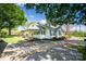 Inviting single-story home with a covered side porch and lush landscaping at 495&501 Turnersburg Hwy, Statesville, NC 28625