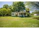 Charming house with green roof and foundation, nestled in a lush green lawn setting at 495&501 Turnersburg Hwy, Statesville, NC 28625