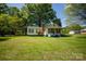 Quaint home featuring a green roof, well-maintained lawn, and classic architectural details at 495&501 Turnersburg Hwy, Statesville, NC 28625
