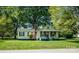 Cozy home with light yellow siding, complemented by a green roof and tidy front yard at 495&501 Turnersburg Hwy, Statesville, NC 28625