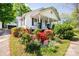 Charming home with a welcoming front porch, surrounded by colorful flowers and lush greenery at 495&501 Turnersburg Hwy, Statesville, NC 28625