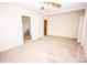 Spacious living room with neutral carpet, natural light, and access to additional rooms at 495&501 Turnersburg Hwy, Statesville, NC 28625