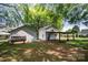 View of outbuildings on a property surrounded by grass and large trees at 495&501 Turnersburg Hwy, Statesville, NC 28625