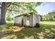 Close up of a shed with a door surrounded by green grass and trees at 495&501 Turnersburg Hwy, Statesville, NC 28625