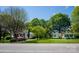 Quaint street view of well-kept homes, showcasing lush greenery and tidy front yards at 495&501 Turnersburg Hwy, Statesville, NC 28625