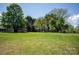 A large green yard with several wooden sheds and mature trees at 495&501 Turnersburg Hwy, Statesville, NC 28625
