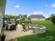 Outdoor patio with dining set and a cozy stone fire pit, perfect for relaxation and entertaining at 5058 Antebellum Dr, Iron Station, NC 28080