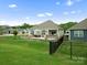 Expansive backyard featuring a stone patio, fenced-in area, and beautifully maintained lawn at 5058 Antebellum Dr, Iron Station, NC 28080