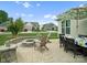 Backyard with a fire pit, dining area, and a nicely manicured lawn at 5058 Antebellum Dr, Iron Station, NC 28080