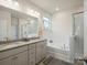 Elegant bathroom with granite countertops, double sinks, soaking tub, and a glass-enclosed shower at 5058 Antebellum Dr, Iron Station, NC 28080