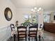 Dining area with view to living room, chandelier, and view of the outdoors at 5058 Antebellum Dr, Iron Station, NC 28080