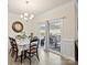 Bright dining room with hardwood floors, chandelier and sliding door access to backyard patio and grill at 5058 Antebellum Dr, Iron Station, NC 28080