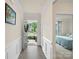 Bright hallway with paneled wainscotting and hardwood floors, showing a view of the front yard at 5058 Antebellum Dr, Iron Station, NC 28080