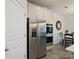 Kitchen with stainless steel refrigerator and built-in double oven, with a view into the dining room at 5058 Antebellum Dr, Iron Station, NC 28080