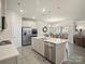 Modern kitchen with stainless steel appliances, a central island and elegant pendant lighting at 5058 Antebellum Dr, Iron Station, NC 28080