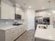 Bright kitchen features stainless appliances, gas cooktop, tile backsplash, and large island with sink at 5058 Antebellum Dr, Iron Station, NC 28080