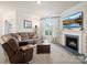 Inviting living room featuring a fireplace, large sectional sofa, and a flat screen TV above the mantle at 5058 Antebellum Dr, Iron Station, NC 28080