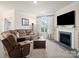 Cozy living room featuring a fireplace, large sectional sofa, and a flat screen TV at 5058 Antebellum Dr, Iron Station, NC 28080