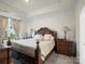 Serene bedroom featuring tray ceiling, neutral color palette, and ample natural light at 5058 Antebellum Dr, Iron Station, NC 28080