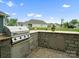 Outdoor kitchen with grill and stone counter offers an ideal space for entertaining at 5058 Antebellum Dr, Iron Station, NC 28080