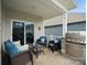 Inviting outdoor patio seating area with comfortable wicker chairs, coffee table and built-in grill at 5058 Antebellum Dr, Iron Station, NC 28080