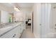 Bathroom featuring double vanity with granite countertops and walk-in shower at 5210 Valley Stream Rd, Charlotte, NC 28209