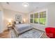 Cozy bedroom with natural light and comfortable furnishings at 5210 Valley Stream Rd, Charlotte, NC 28209