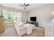 Bedroom with a comfortable sectional couch and a window with natural light at 5210 Valley Stream Rd, Charlotte, NC 28209