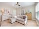 Bedroom with a neutral sectional couch, two dressers, and hardwood flooring at 5210 Valley Stream Rd, Charlotte, NC 28209