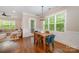 Cozy dining area with hardwood floors and natural light, seamlessly connected to the living room at 5210 Valley Stream Rd, Charlotte, NC 28209