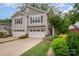 Charming exterior of a two-story home with a two-car garage and well-manicured landscaping at 5210 Valley Stream Rd, Charlotte, NC 28209