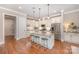 Bright kitchen with white cabinets, granite countertops, stainless steel appliances, and a spacious island at 5210 Valley Stream Rd, Charlotte, NC 28209