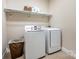 This laundry room has modern appliances and plenty of shelf space for storage at 5210 Valley Stream Rd, Charlotte, NC 28209