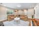 Open-concept living room with lots of light, plush seating, and stylish decor at 5210 Valley Stream Rd, Charlotte, NC 28209
