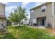 Backyard view highlighting a patio, grill, and green space, offering a glimpse of outdoor living and relaxation at 5257 Glenlea Walk Ln, Charlotte, NC 28216