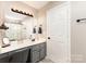 Bathroom vanity with gray cabinets, and luxury vinyl plank flooring at 5257 Glenlea Walk Ln, Charlotte, NC 28216