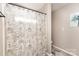 Shower and toilet area in the bathroom with luxury vinyl plank flooring at 5257 Glenlea Walk Ln, Charlotte, NC 28216