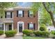 Charming two-story brick home with well-maintained landscaping and black shutters at 5257 Glenlea Walk Ln, Charlotte, NC 28216