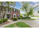 Inviting townhouse with brick facade, trimmed bushes and trees, providing a sense of welcome at 5257 Glenlea Walk Ln, Charlotte, NC 28216