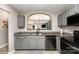 This open kitchen features gray cabinets, granite countertops, and a stainless steel dishwasher at 5257 Glenlea Walk Ln, Charlotte, NC 28216
